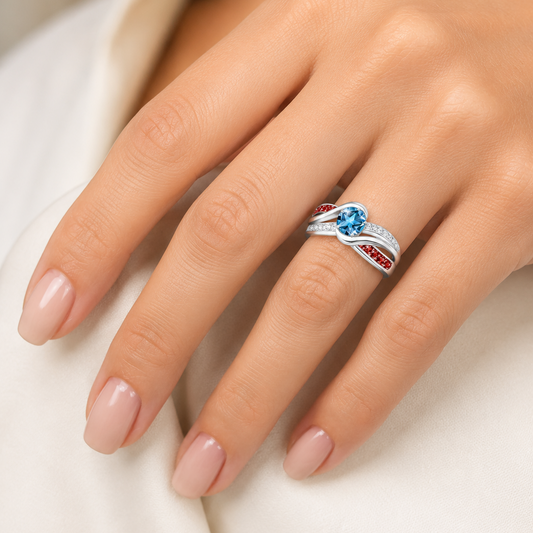 Close-up of a hand wearing a silver ring with gemstones on a neutral background