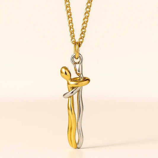 Gold and silver pendant necklace on a beige background