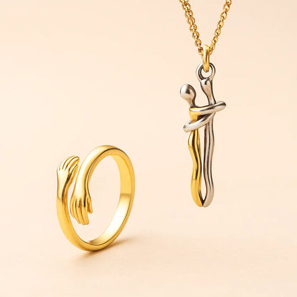 Gold ring and necklace set on a beige background