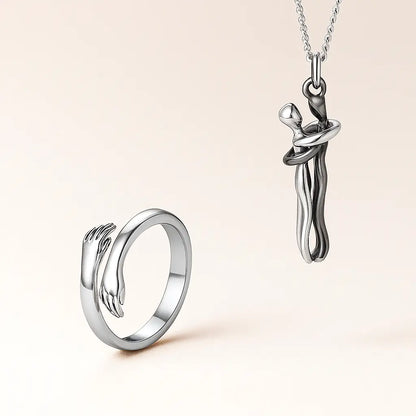 Silver ring and pendant set on a beige background