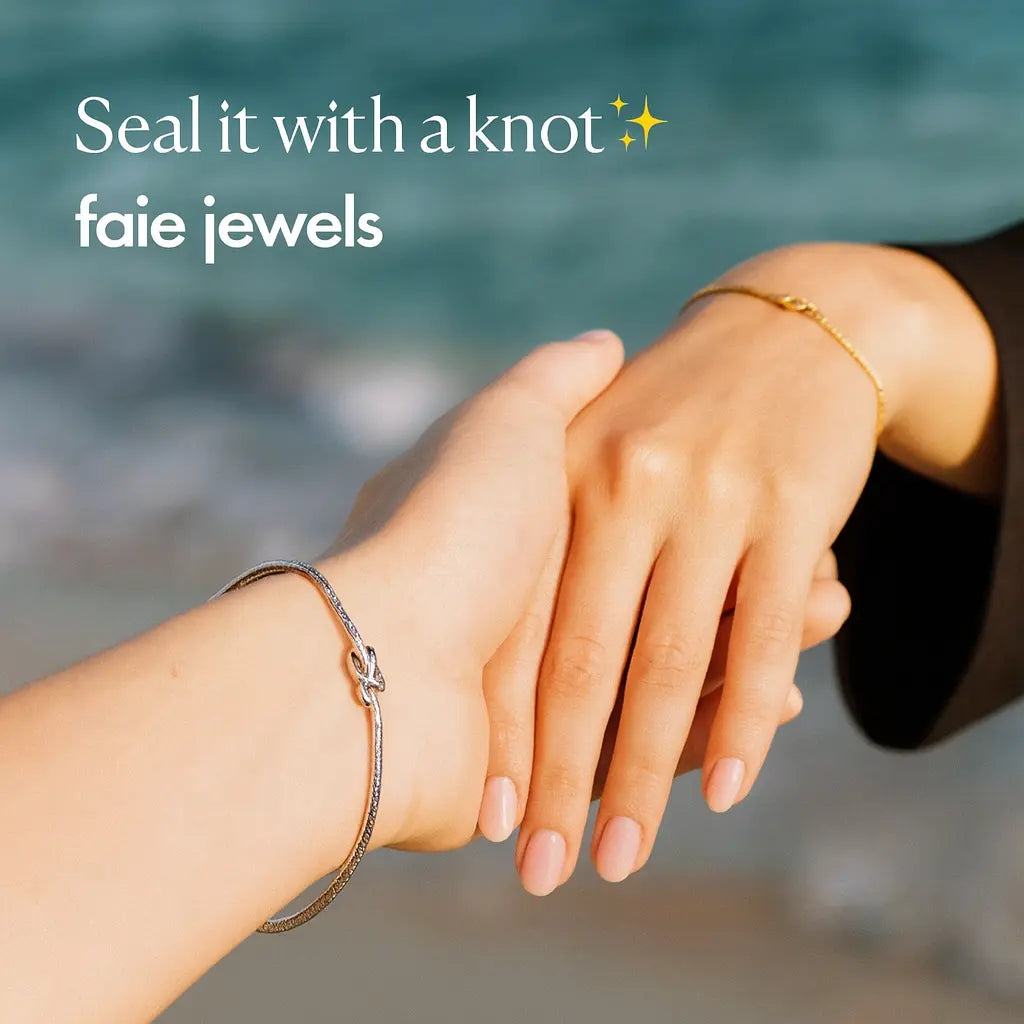 Two hands holding each other with bracelets on, against a blurred natural background, featuring 'faie jewels' branding.