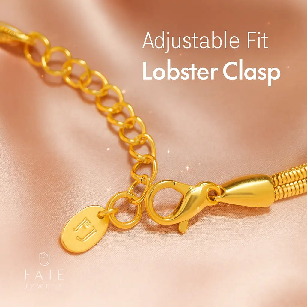 Gold bracelet with lobster clasp on a soft pink background